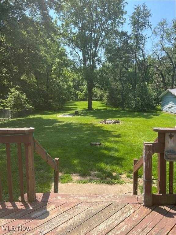 3290 NW Sweitzer St NW, Uniontown, OH 44685 - view of green lawn featuring a wooden deck