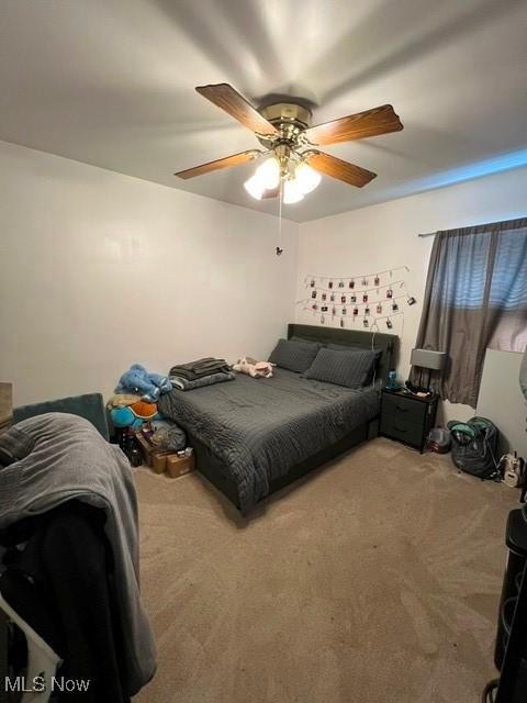 3290 NW Sweitzer St NW, Uniontown, OH 44685 - carpeted bedroom with a ceiling fan