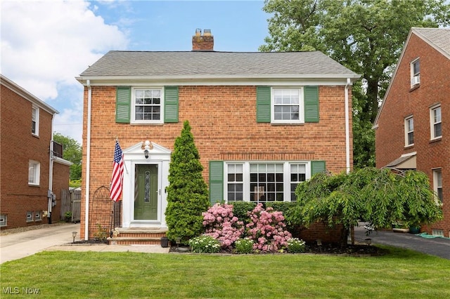 3678 Lynnfield Rd, Shaker Heights, OH 44122 - colonial-style house featuring a front yard, brick siding, and a chimney