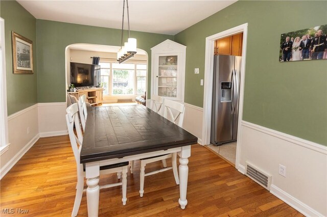 3678 Lynnfield Rd, Shaker Heights, OH 44122 - dining space featuring light wood-style floors, a chandelier, and arched walkways