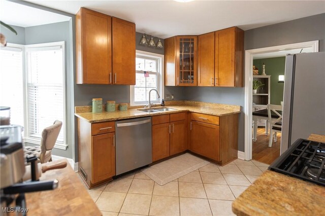 3678 Lynnfield Rd, Shaker Heights, OH 44122 - kitchen with appliances with stainless steel finishes, brown cabinetry, glass insert cabinets, and light tile patterned flooring