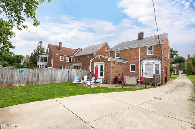 3678 Lynnfield Rd, Shaker Heights, OH 44122 - rear view of house featuring an outdoor fire pit, a chimney, brick siding, and a patio