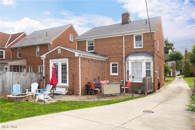 3678 Lynnfield Rd, Shaker Heights, OH 44122 - rear view of property with an outdoor fire pit, brick siding, entry steps, and a chimney