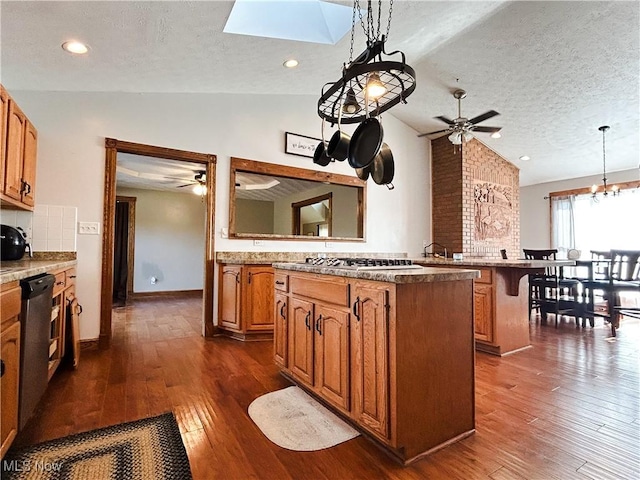3585 Hayfield Rd, Dresden, OH 43821 - kitchen featuring vaulted ceiling, stainless steel appliances, a ceiling fan, a textured ceiling, and brown cabinetry