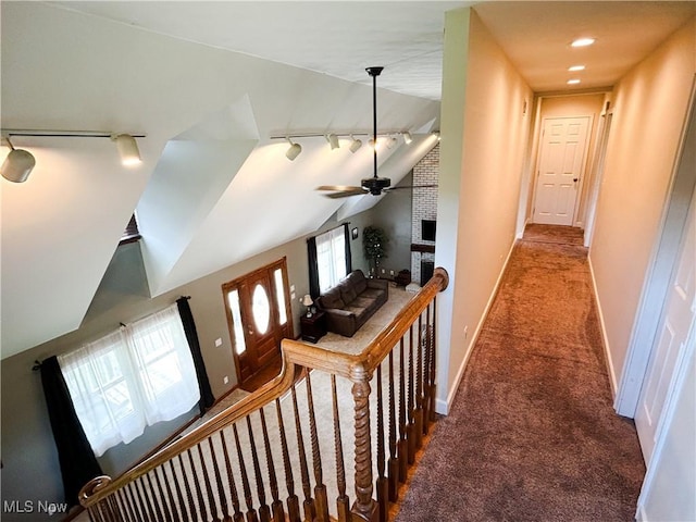 3585 Hayfield Rd, Dresden, OH 43821 - hall featuring rail lighting, carpet floors, vaulted ceiling, and an upstairs landing