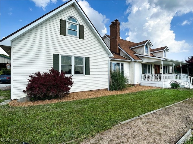 3585 Hayfield Rd, Dresden, OH 43821 - back of house with covered porch and a lawn