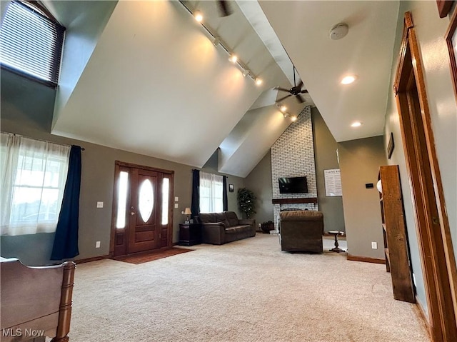 3585 Hayfield Rd, Dresden, OH 43821 - entryway with carpet, rail lighting, ceiling fan, lofted ceiling, and a brick fireplace
