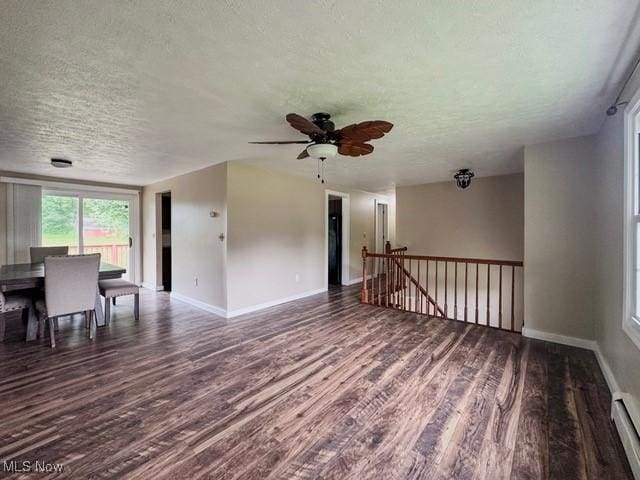 503 W Pidgeon Rd, Salem, OH 44460 - unfurnished living room with a textured ceiling, wood finished floors, a ceiling fan, and a baseboard heating unit