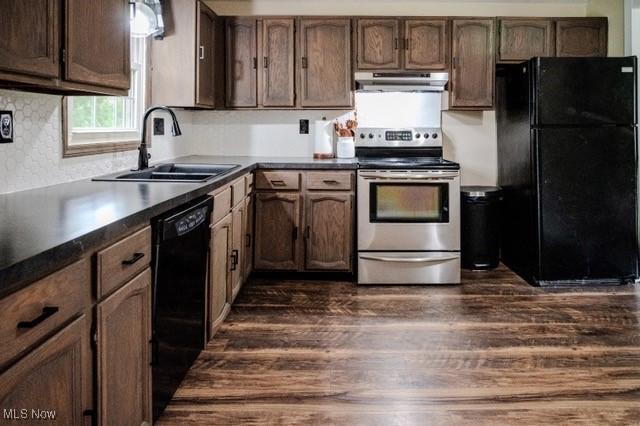 503 W Pidgeon Rd, Salem, OH 44460 - kitchen with black appliances, under cabinet range hood, dark wood finished floors, and dark countertops