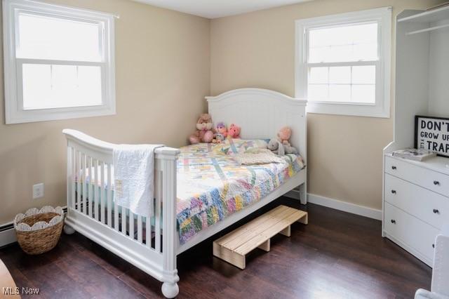503 W Pidgeon Rd, Salem, OH 44460 - bedroom with dark wood-style flooring and a baseboard heating unit