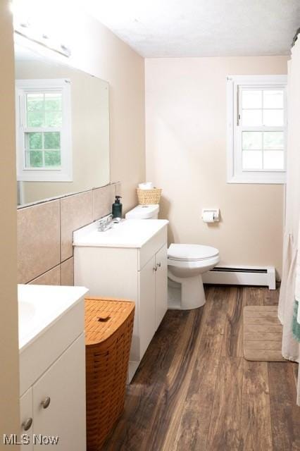 503 W Pidgeon Rd, Salem, OH 44460 - full bathroom with baseboard heating, wood finished floors, vanity, and a shower with shower curtain