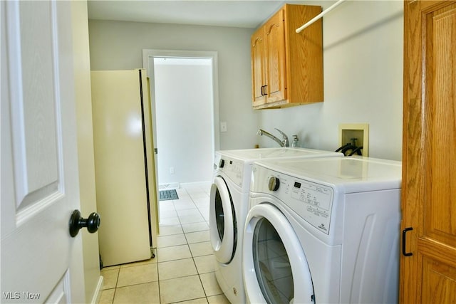 2878 Beaver Trl, Cortland, OH 44410 - laundry area with washing machine and clothes dryer, cabinet space, and light tile patterned floors