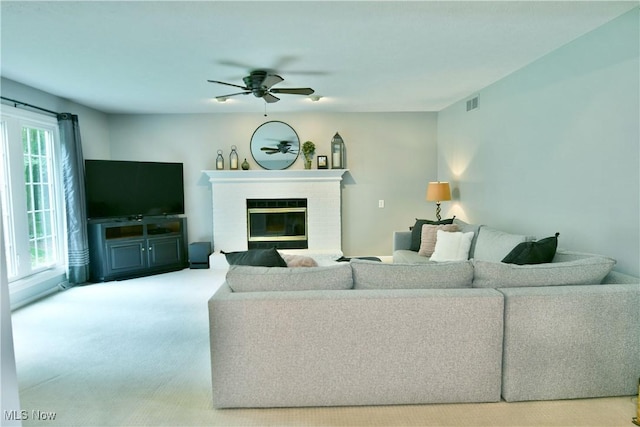 2878 Beaver Trl, Cortland, OH 44410 - living area with ceiling fan, carpet floors, and a brick fireplace