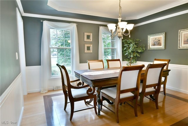 2878 Beaver Trl, Cortland, OH 44410 - dining area with a chandelier, crown molding, light wood finished floors, and wainscoting
