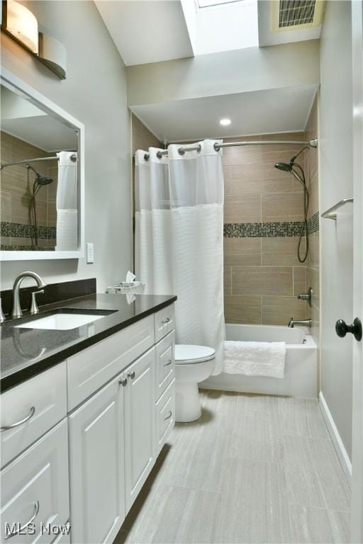 2878 Beaver Trl, Cortland, OH 44410 - bathroom with vanity, shower / bathtub combination with curtain, and a skylight