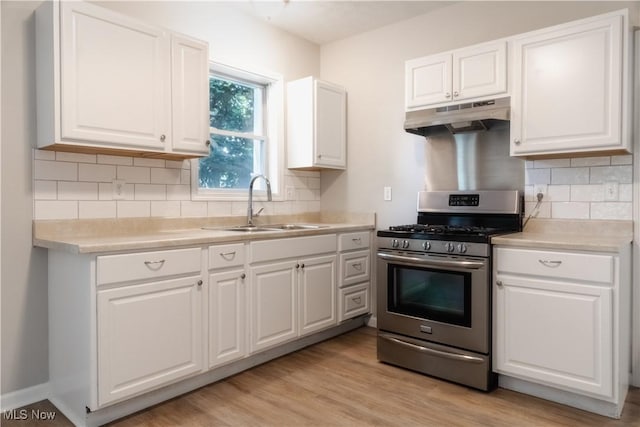 5458 Ridgewood, Lorain, OH 44055 - kitchen with stainless steel range with gas stovetop, under cabinet range hood, white cabinets, and light countertops