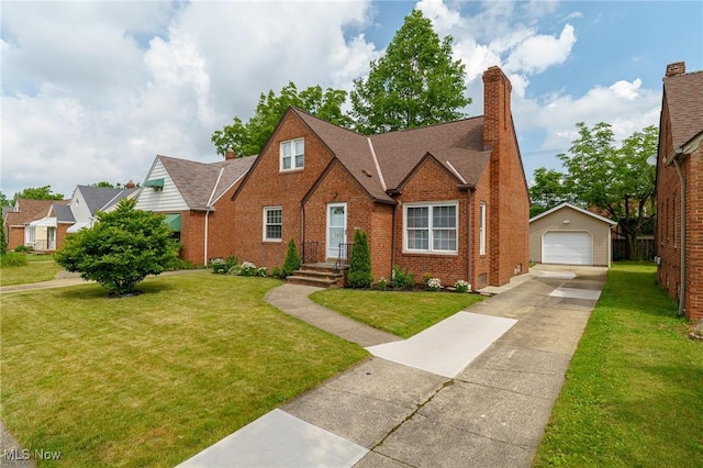 3975 Eastway Rd, South Euclid, OH 44118 - view of front of house featuring a detached garage, brick siding, an outdoor structure, and a front lawn
