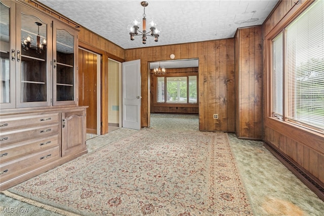 11861 Moffitt St SW, Massillon, OH 44647 - unfurnished dining area with a chandelier and wooden walls