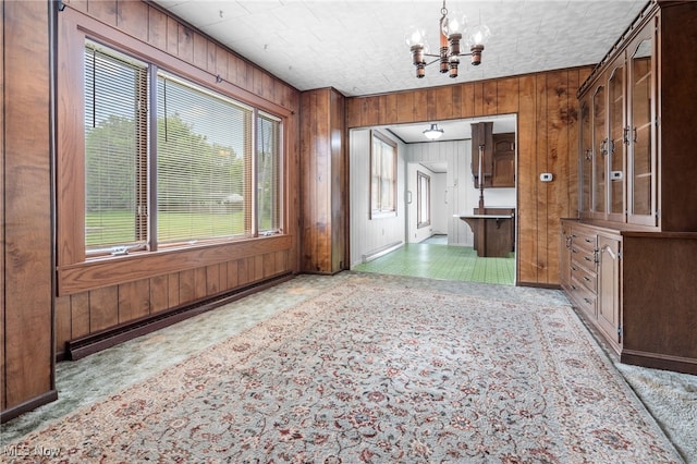 11861 Moffitt St SW, Massillon, OH 44647 - unfurnished dining area featuring a chandelier and wood walls