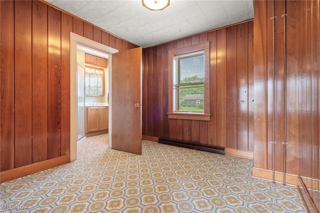 11861 Moffitt St SW, Massillon, OH 44647 - empty room featuring wooden walls and a baseboard heating unit