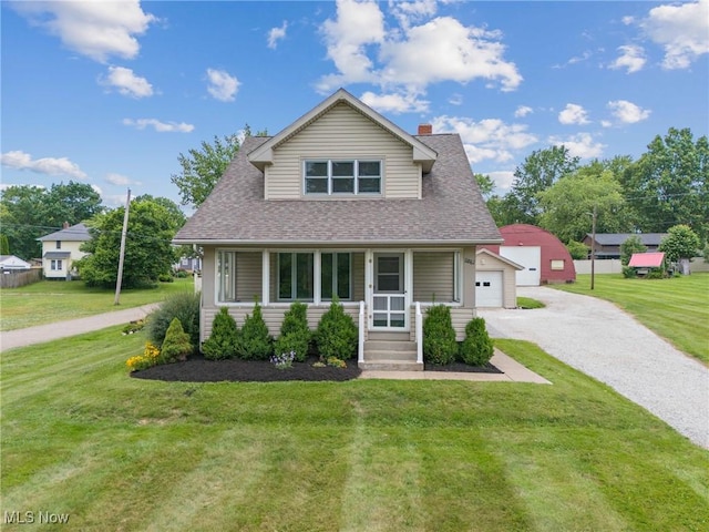11861 Moffitt St SW, Massillon, OH 44647 - bungalow-style home featuring gravel driveway, a front yard, an outbuilding, a detached garage, and roof with shingles