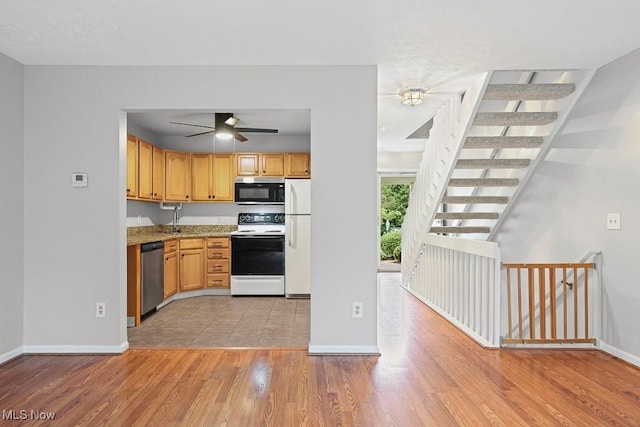 713 Gold Leaf, Streetsboro, OH 44241 - kitchen featuring range with electric stovetop, stainless steel dishwasher, freestanding refrigerator, ceiling fan, and light wood finished floors