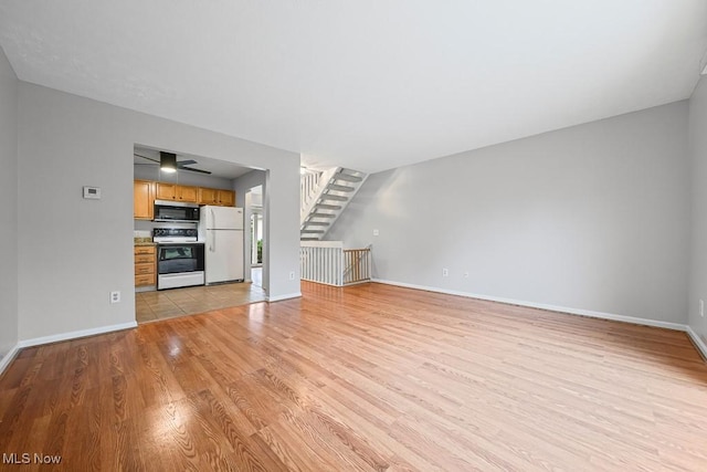 713 Gold Leaf, Streetsboro, OH 44241 - unfurnished living room featuring light wood-style floors and stairway