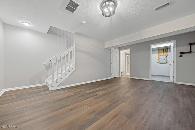 713 Gold Leaf, Streetsboro, OH 44241 - unfurnished living room featuring stairway, a textured ceiling, and wood finished floors
