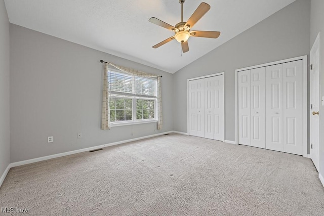 713 Gold Leaf, Streetsboro, OH 44241 - unfurnished bedroom with multiple closets, lofted ceiling, carpet floors, and a ceiling fan