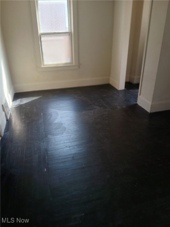 1954 Everett Ave, Youngstown, OH 44514 - unfurnished room featuring baseboards and dark wood-style flooring
