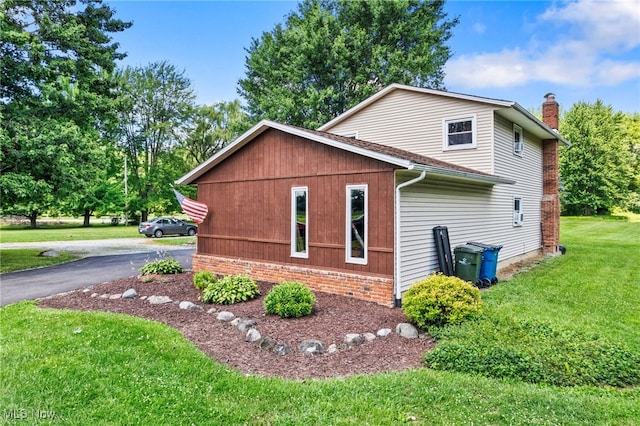 40698 Whitney Rd, Lagrange, OH 44050 - view of home's exterior with a lawn, a chimney, and brick siding