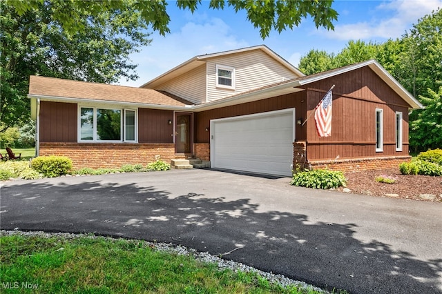 40698 Whitney Rd, Lagrange, OH 44050 - view of front of house with brick siding, a garage, and asphalt driveway