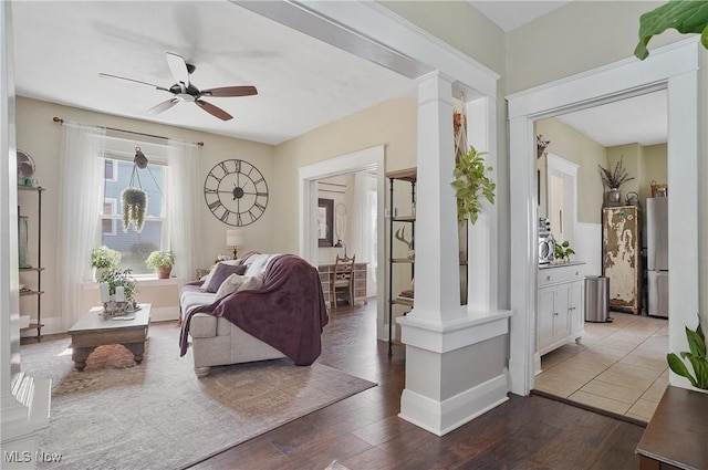 583 E 7th St, Salem, OH 44460 - living room featuring a ceiling fan, wood finished floors, and decorative columns