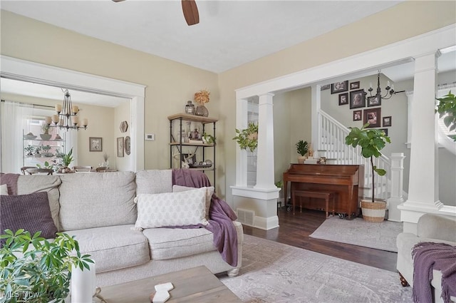 583 E 7th St, Salem, OH 44460 - living room with a chandelier, wood finished floors, decorative columns, ceiling fan, and stairway