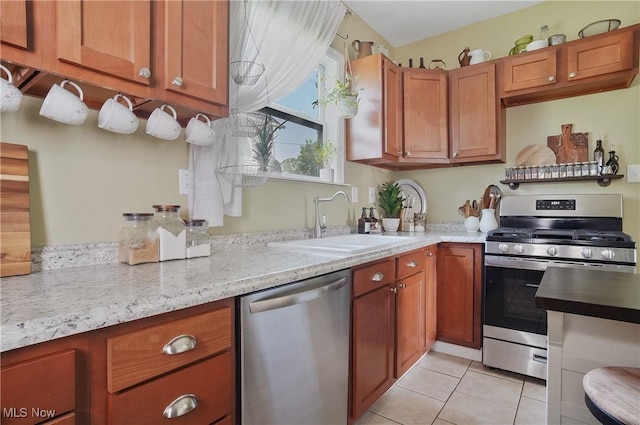 583 E 7th St, Salem, OH 44460 - kitchen with appliances with stainless steel finishes, light tile patterned floors, brown cabinets, and light stone countertops