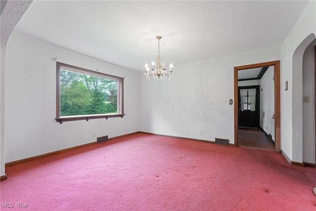 5352 Hills And Dales Rd NW, Canton, OH 44708 - unfurnished room with arched walkways, carpet, and a chandelier