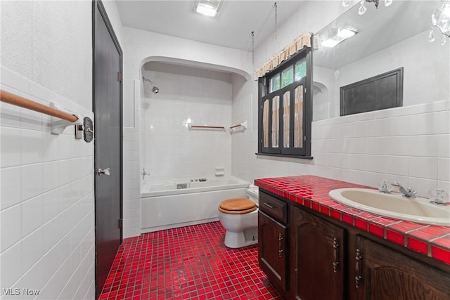 5352 Hills And Dales Rd NW, Canton, OH 44708 - full bathroom featuring tile walls, vanity, washtub / shower combination, and tile patterned floors