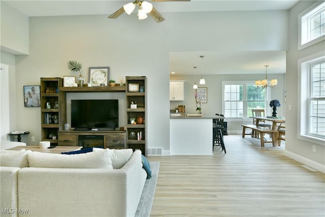 125 Fitch Blvd Unit 254, Youngstown, OH 44515 - living area with light wood finished floors, healthy amount of natural light, ceiling fan, a chandelier, and a towering ceiling