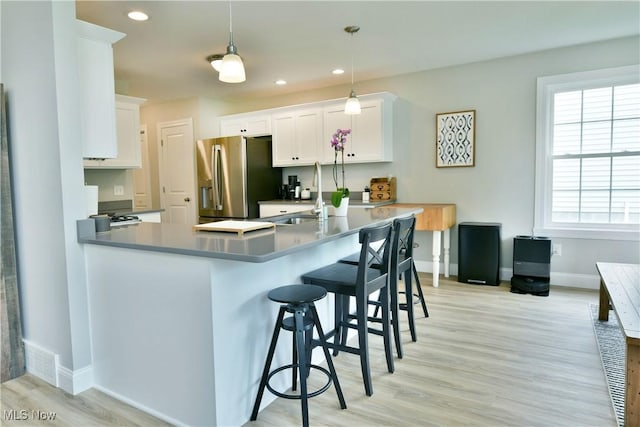 125 Fitch Blvd Unit 254, Youngstown, OH 44515 - kitchen featuring stainless steel fridge, light wood-style floors, white cabinets, a peninsula, and recessed lighting