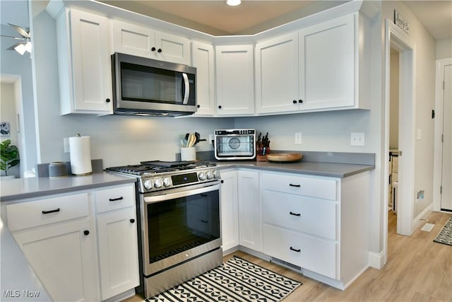 125 Fitch Blvd Unit 254, Youngstown, OH 44515 - kitchen with stainless steel appliances, light wood-style floors, white cabinets, recessed lighting, and a ceiling fan