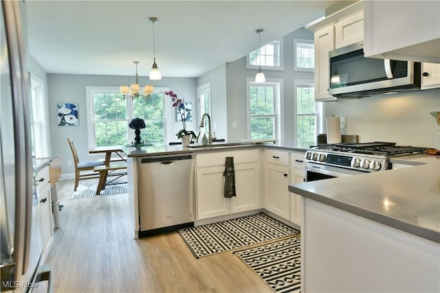 125 Fitch Blvd Unit 254, Youngstown, OH 44515 - kitchen with stainless steel appliances, light wood-style flooring, white cabinetry, and a chandelier