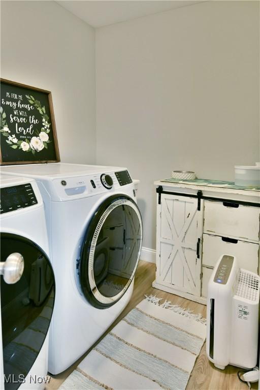 125 Fitch Blvd Unit 254, Youngstown, OH 44515 - laundry area featuring washing machine and clothes dryer and light wood-style flooring