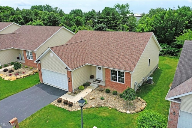 125 Fitch Blvd Unit 254, Youngstown, OH 44515 - view of front facade featuring brick siding, asphalt driveway, a front lawn, and a garage