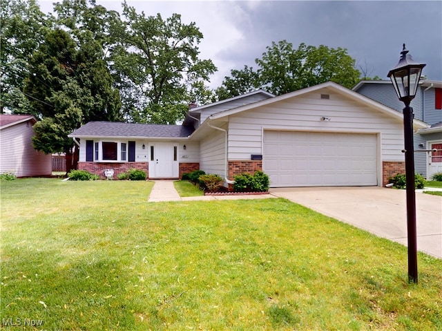 451 Edgewood Cir, Berea, OH 44017 - view of front of house featuring brick siding, an attached garage, concrete driveway, and a front yard