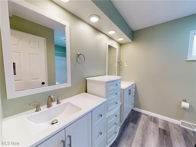 451 Edgewood Cir, Berea, OH 44017 - full bathroom featuring two vanities, wood finished floors, and recessed lighting