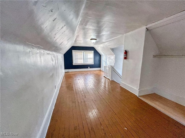 421 E Thornton St, Akron, OH 44311 - additional living space with vaulted ceiling, hardwood / wood-style flooring, and a textured ceiling