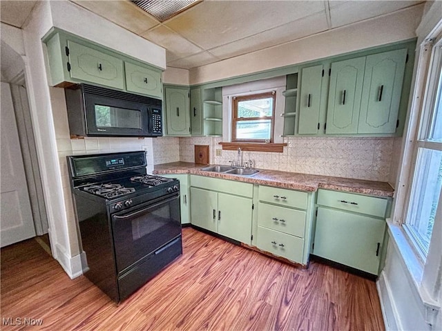 421 E Thornton St, Akron, OH 44311 - kitchen with black appliances, open shelves, green cabinets, and light wood-style flooring
