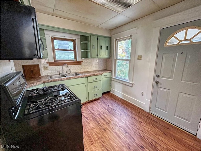 421 E Thornton St, Akron, OH 44311 - kitchen with green cabinets, black range with gas cooktop, plenty of natural light, and decorative backsplash