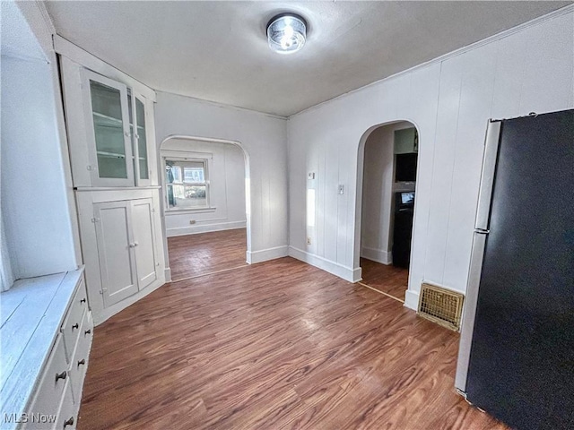 421 E Thornton St, Akron, OH 44311 - unfurnished dining area with arched walkways and wood finished floors