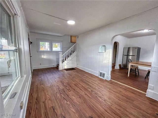 421 E Thornton St, Akron, OH 44311 - unfurnished living room featuring arched walkways, wood finished floors, and stairs